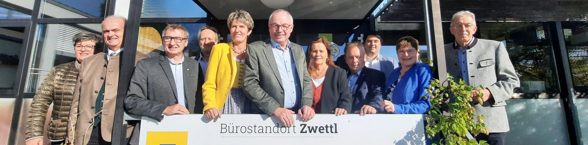 Bild von der Eröffnung des neuen "Haus der Region" in Zwettl. Personen mit Schildern der Organisationen.